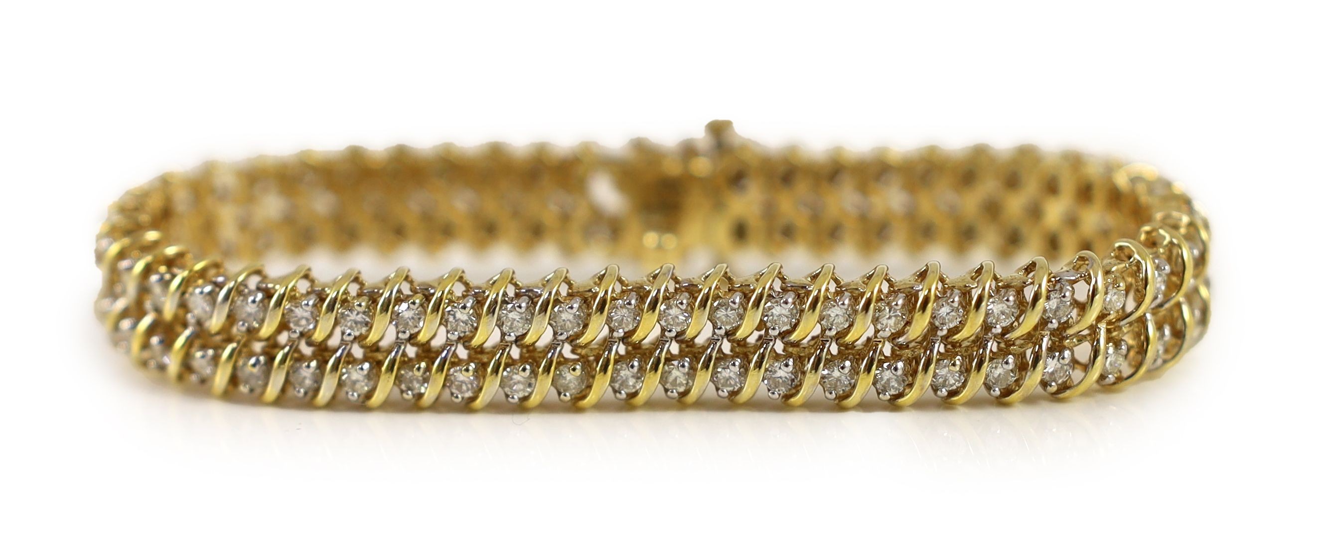 A modern 14k gold and twin row diamond set line bracelet